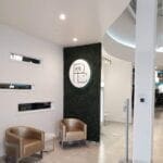 fitness center reception design at Palm Beach Sports Club with green wall logo and seating by Optimal Design Systems International
