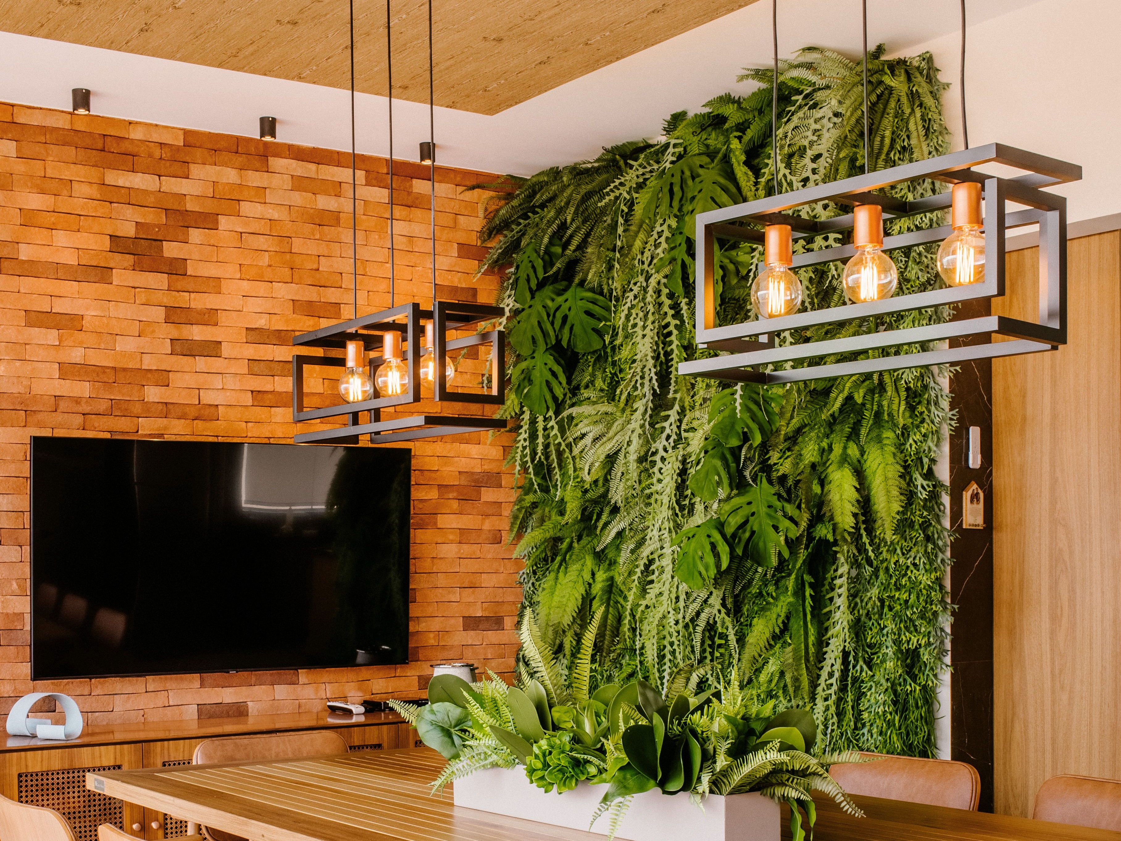 A dining room with a lush vertical garden wall or living plant wall