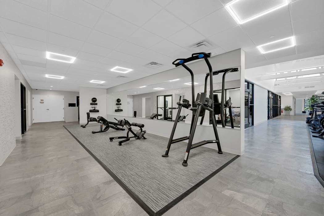 Modern corporate fitness room with benches and functional training station