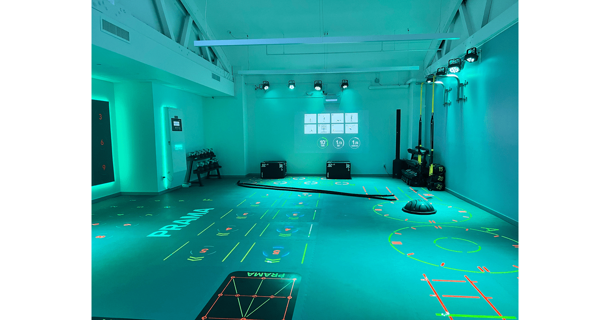 Turquoise studio with interactive floor markings and training gear.