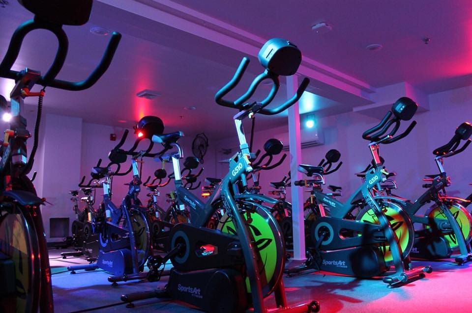 A cycling room with stationary bikes inside a boutique gym