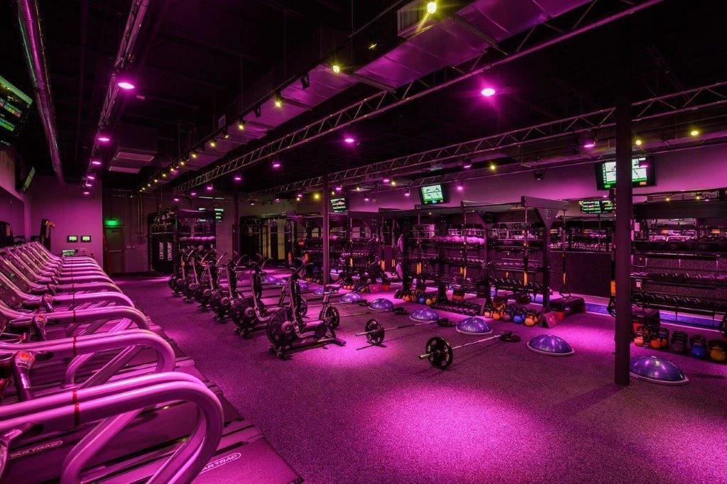Pink-lit cardio/strength zone at Regymen Fitness