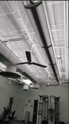 Exercise space design of Longfellow Lumina Studio before renovation with exposed ceiling and suspended linear lighting.